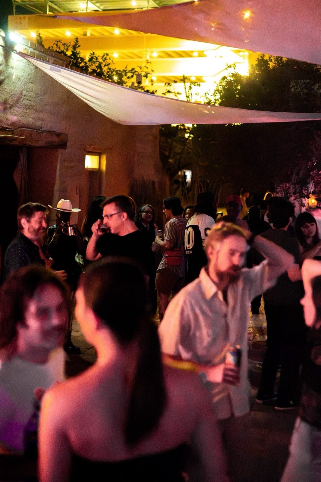 A crowd dancing outdoors at night